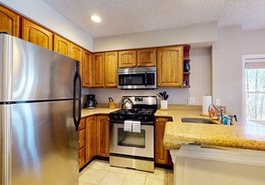 Ski-in/out condo near lifts with a fireplace, pool, hot tub, & tennis
