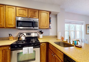 Ski-in/out condo near lifts with a fireplace, pool, hot tub, & tennis