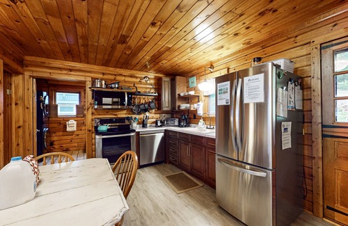 Valois House | 1-acre lakefront log cabin with dock, 50 ft water frontage, hot tub, & deck