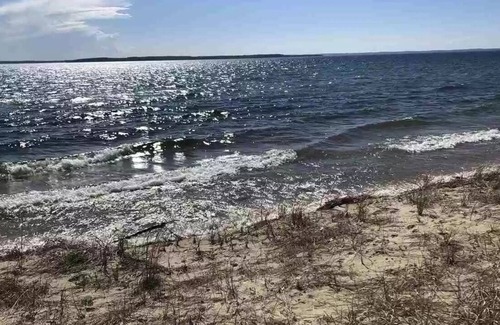 Kewadin House | 100' gorgeous sandy GT bay frontage only 15 miles from TC