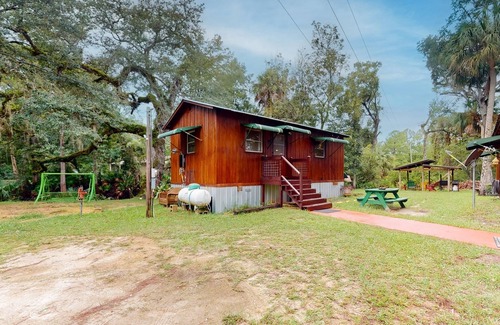 Bronson Cabin | 2 riverfront cabins with large yard, grill, firepit, canoe, & private W/D