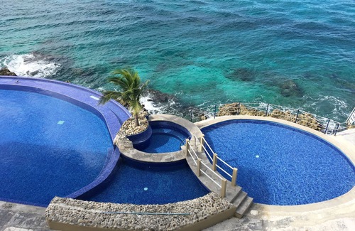 Colonos Cuzamil Condo | 4/4.5 Condo Oceanfront Cozumel Downtown AC WiFi Security