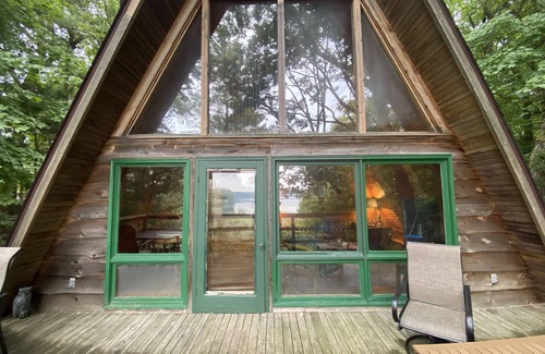 Allegan House | A-frame cabin nestled in forest, stunning lake view, perfect serenity.