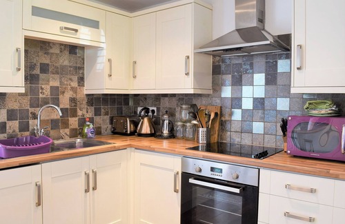 Rhuddlan Cottage | A picturesque cottage nestled in a quiet lane opposite the remains of Rhuddlan Castle .