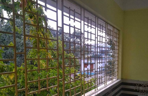 Siliguri Apartment | Bashundhara- A beautiful, spacious room with a bath and balcony.