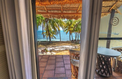 Isla Mujeres Cottage | Beachfront palapa cottage with heated pool , sunsets and tropical gardens