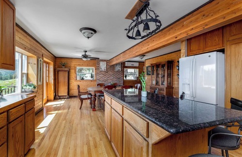 Kettle Falls House | Beautiful 5-bedroom log home with spacious rooms and rustic charm.