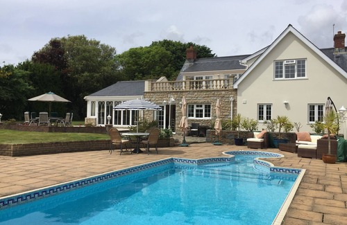 Village de Putron House | Beautiful five bedroomed family home in Guernsey with heated pool