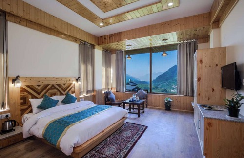 Manali Ski Chalet | Bedroom in a stone and wood chalet admist apple garden