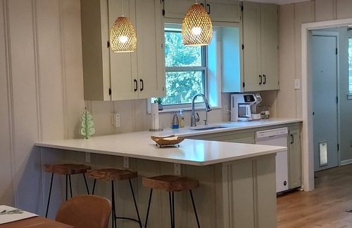 Longview House | Bright and airy Mid-Century Modern home with screened porch and firepit.