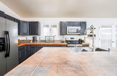 Northeast Anchorage House | Bright modern home with private hot tub, fireplace, enclosed yard, & WiFi