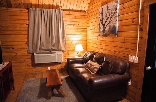 Hattieville Cabin | Charming cabin with loft, porch swing, AC, and WiFi on 295-acre peaceful retreat