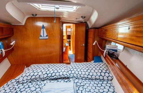 Bari City Centre Boat Rental | Charming sailing boat - in front of the city skyline
