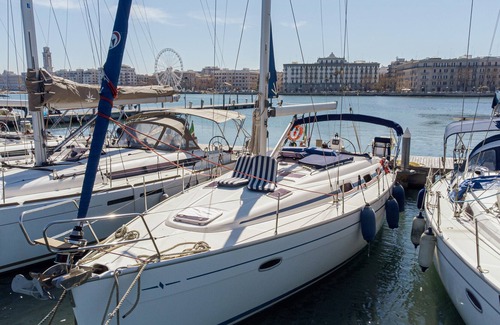 Bari City Centre Boat Rental | Charming sailing boat - in front of the city skyline