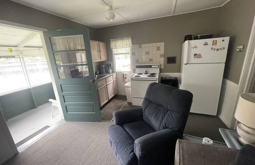 Ludington Cottage | Cottage 3 is a charming 2 bedroom 25’ from your boat dock & Hamlin lake.