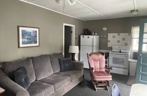 Ludington Cottage | Cottage 3 is a charming 2 bedroom 25’ from your boat dock & Hamlin lake.