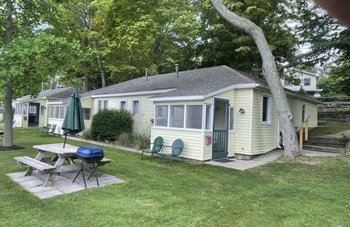 Ludington Cottage | Cottage 4 is a charming 2 bedroom 25’ from your boat dock & Hamlin lake