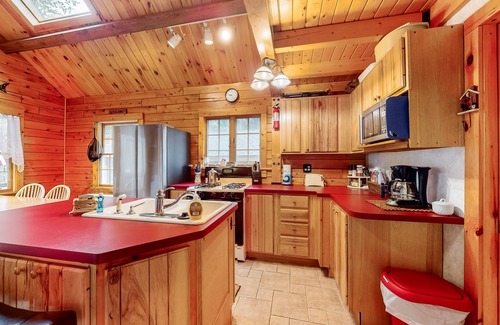 Beaver Cove House | Cozy cabin with covered porch, firepit, grill, fireplace, & washer/dryer