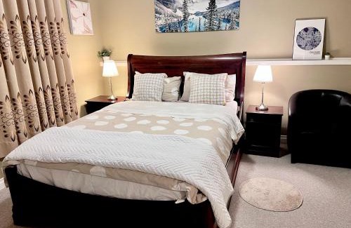Southwest Calgary House | Cozy Walkout suite with King bed, Kitchen, Parking & Patio