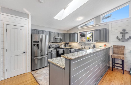 Rehoboth by the Sea House | Dewey Beach home with enclosed lanai, hot tub, patio & firepit - 1 dog welcome