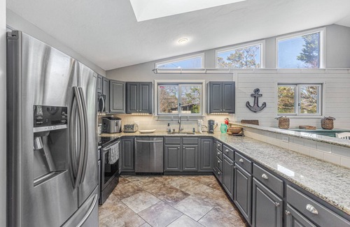 Rehoboth by the Sea House | Dewey Beach home with enclosed lanai, hot tub, patio & firepit - 1 dog welcome