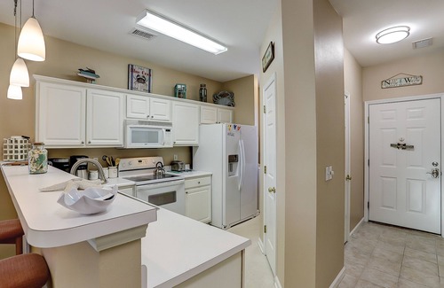 Sunset Beach Condo | Dog-friendly condo with balcony, pool access, & W/D - near beach and golf