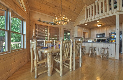 Mineral Bluff Cabin | Eagle Ridge, is pet-friendly haven with a full fenced area and offers awe-inspiring mountain views, a bubbling hot tub, cozy outdoor fireplace, and reliable WiFi.