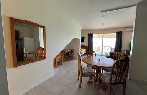St. John's House | Enjoy breathtaking ocean views from a private patio, steps away from the beach.