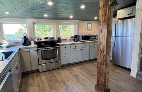Mid-Coast and Islands House | Enjoy picturesque inlet views of a working harbor and sunny days at your oceanfront cottage