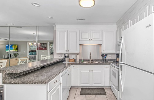 Surfside Beach Condo | Enjoy the warm breeze from your balcony. Baste in the sun. Walk to dinner!n