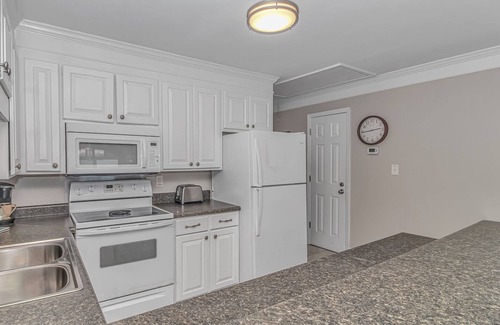 Surfside Beach Condo | Enjoy the warm breeze from your balcony. Baste in the sun. Walk to dinner!n