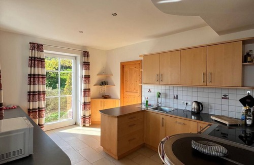 Kurtatsch an der Weinstraße House | Family apartment with playground and terrace surrounded by vineyards