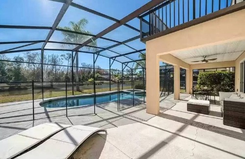 Lake Wilson Preserve House | Gorgeous water view from South facing pool deck. Balcony off upstairs master bed