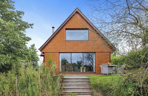 Menai Bridge Ski Chalet | Ground floor: Spacious open plan lounge, kitchen, dining area with log burner.