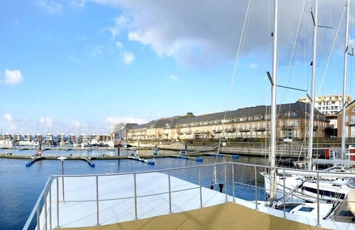 Flensburg Boat Rental | Houseboat Luv in Sonwik harbor with a view of Denmark