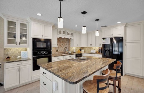Palm Harbor House | Huge Heated Saltwater Pool, Dock, Games & Waterfront Fun