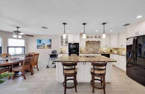 Palm Harbor House | Huge Heated Saltwater Pool, Dock, Games & Waterfront Fun
