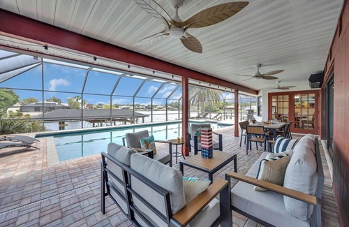 Palm Harbor House | Huge Heated Saltwater Pool, Dock, Games & Waterfront Fun