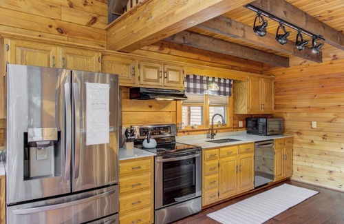 Cedarhurst Cabin | Log Cabin with living room fireplace and hot tub