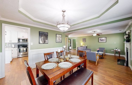 Cameron House | Lovely home with screened-in patio, fireplace, pool, playground, & gym access