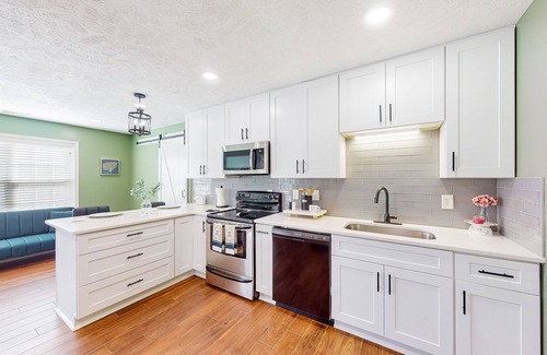 Cameron House | Lovely home with screened-in patio, fireplace, pool, playground, & gym access