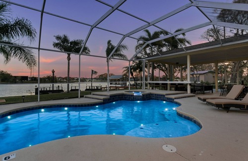 Westchase House | Luxe Waterfront Hideaway w Pool & Pirate Ship Dock