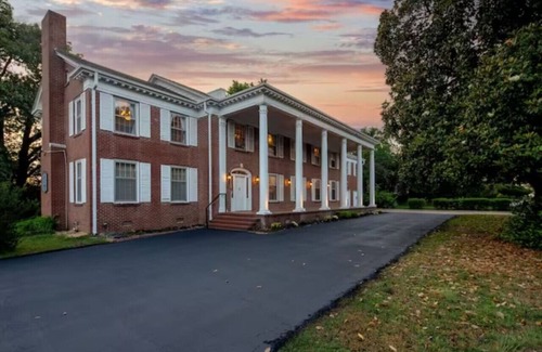 Fort Smith House | Magnolia suite with queen size bed, sitting area, soaking tub and smart tv
