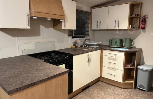 Lossiemouth House | Metres from the beach. Cosy, family friendly mobile home with decking.