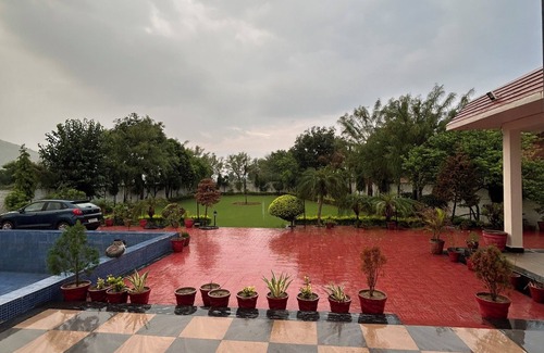 Alwar Other | Nestled amidst majestic mountains, our farmhouse offers a serene and picturesque