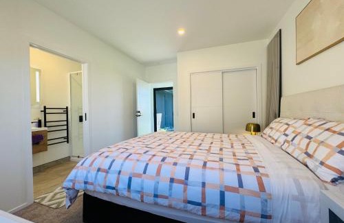 Wharewaka House | New house has bedroom with attached bathroom