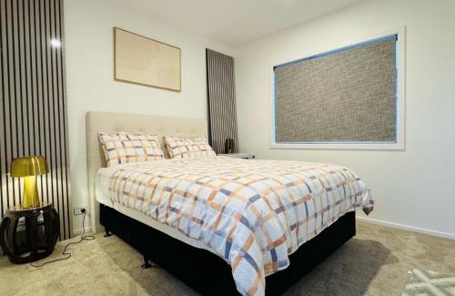 Wharewaka House | New house has bedroom with attached bathroom