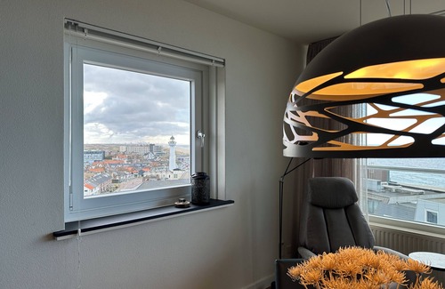 Egmond aan Zee House | NEW IN OUR OFFER! The corner apartment Sterflat221 is located on the 9th floor, on the sunny south-west side. It offers you a wonderful view of the beach, North Sea, village and dunes. Thanks to the altitude and the perfect position of the sun, you almos