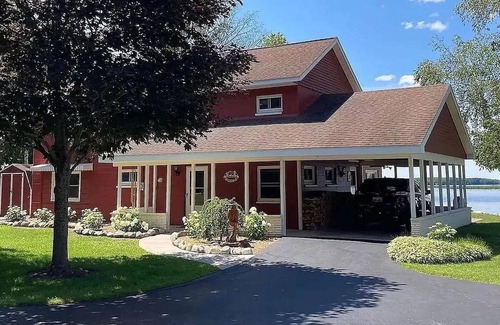 Alpena House | NEW LISTING! Spacious 4-bedrooms lake front retreat in delightful Alpena area.