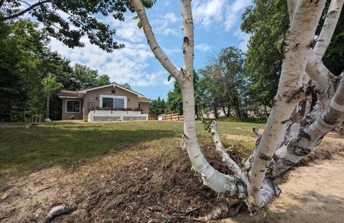 Carp Lake Cottage | NEW! Renovated lakeside cottage with a private sandy beach. Great Location!